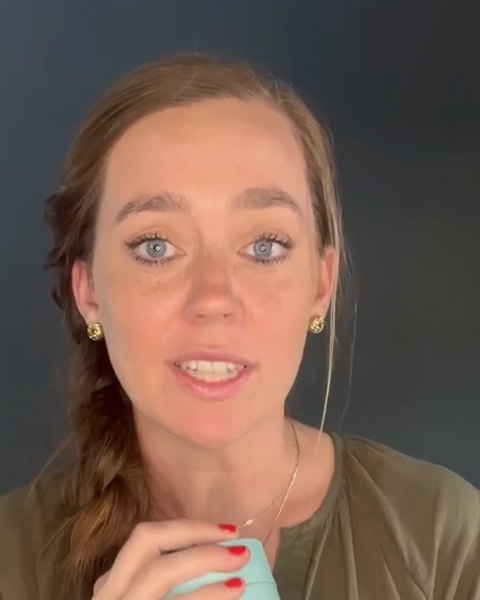 A woman talking about her mint green travel mug